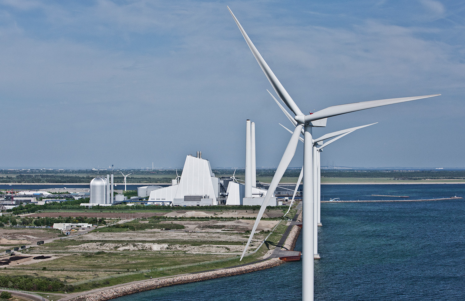 Power plant wit windmills by the water
