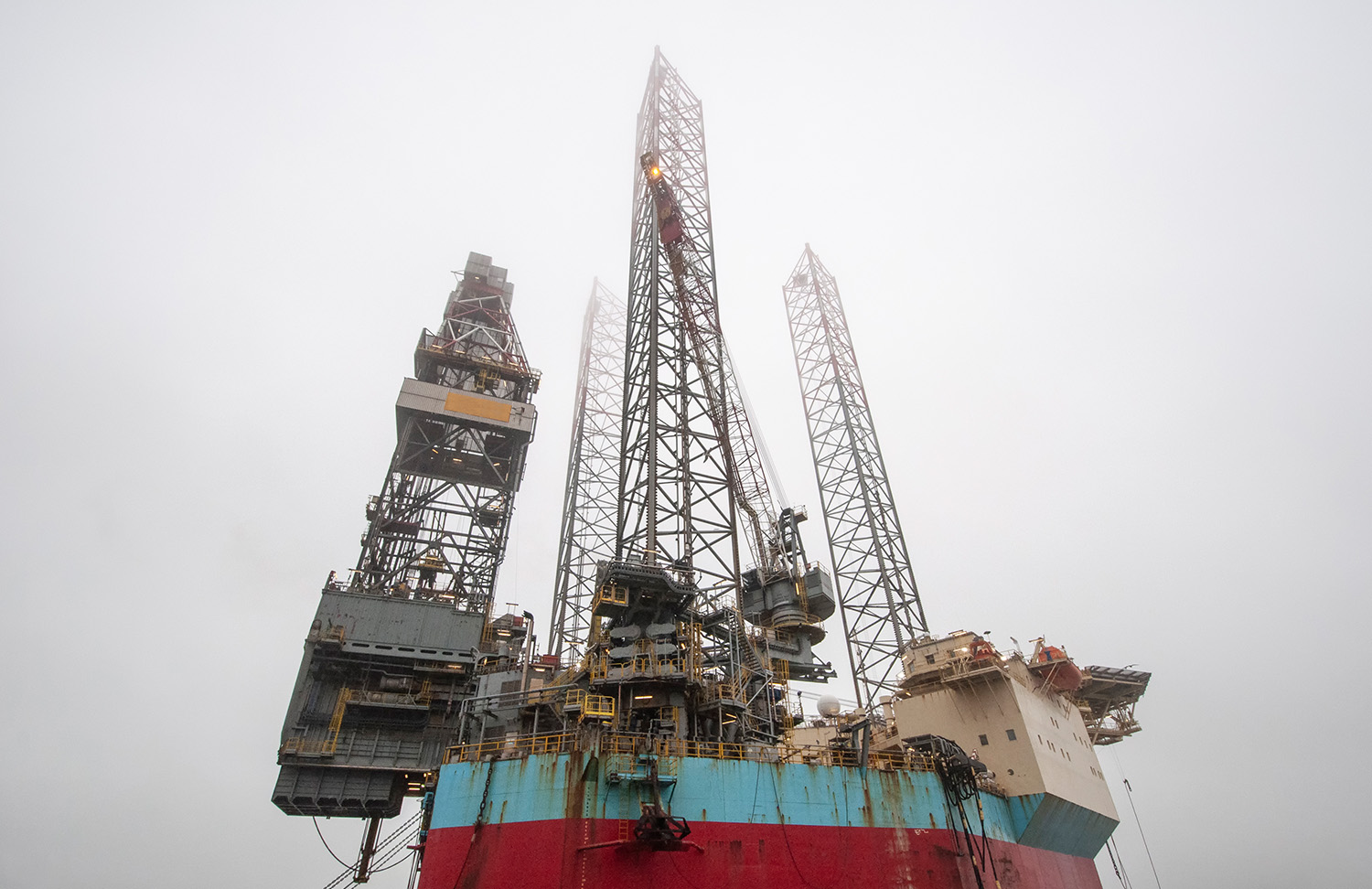 Oil rig from below with grey skies