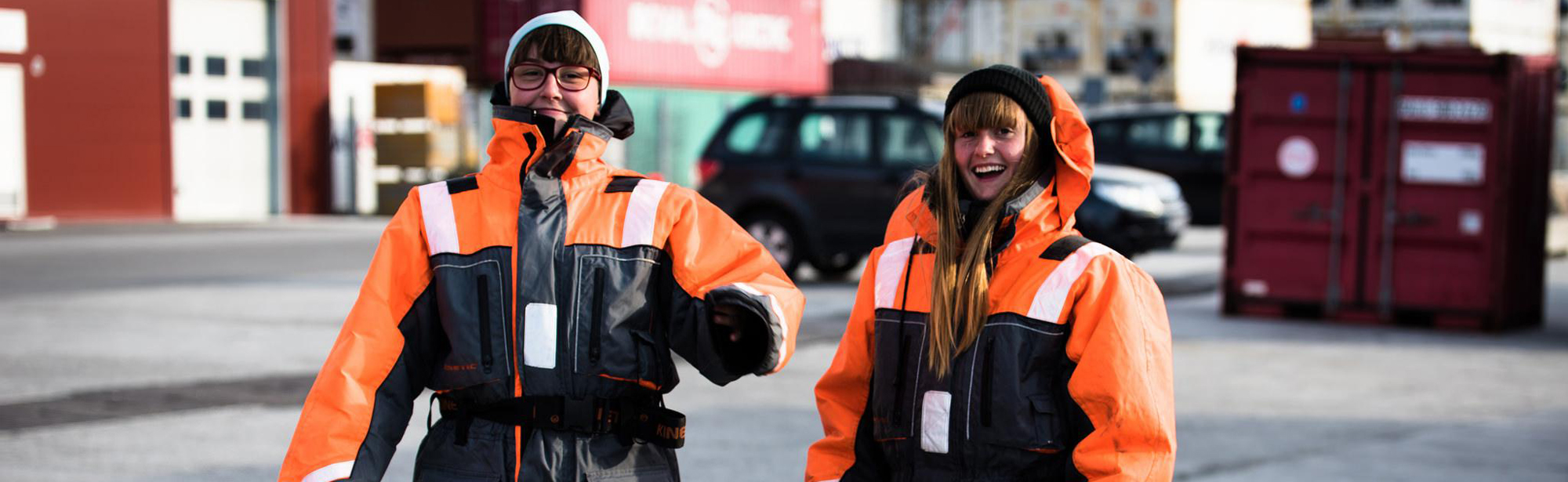 Two girls dressed in big overalls in Greenland