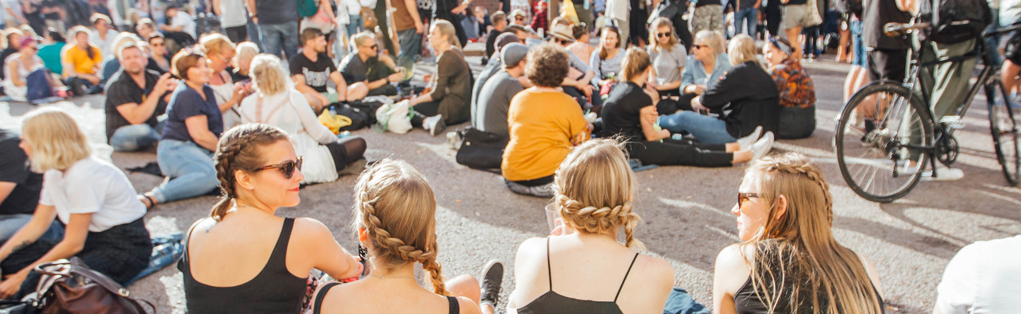 Young people sitting on a street in Helsinki