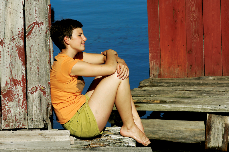 Girl sitting on wharf