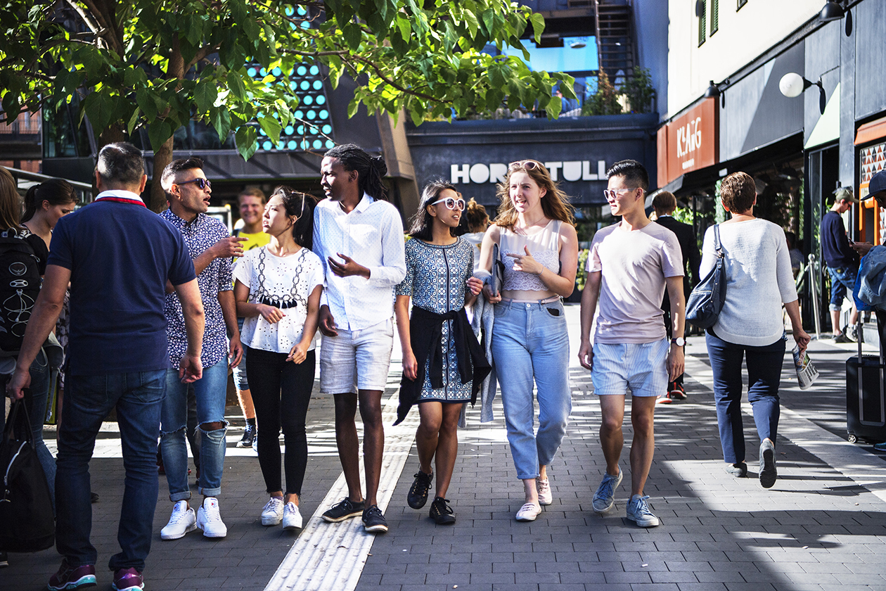 Yong people with different ethnicities walking on a street