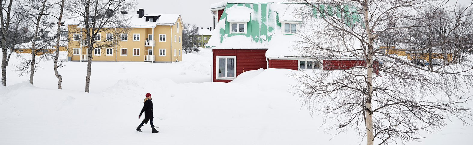 Person walking in snowy village