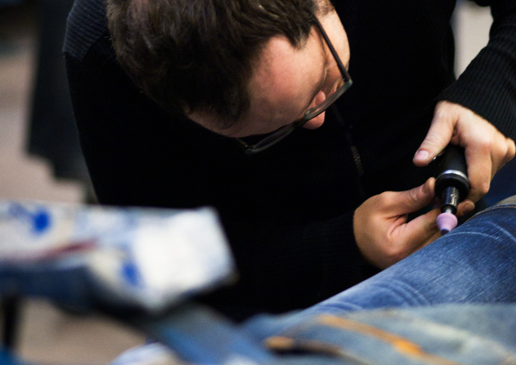 Man sewing jeans