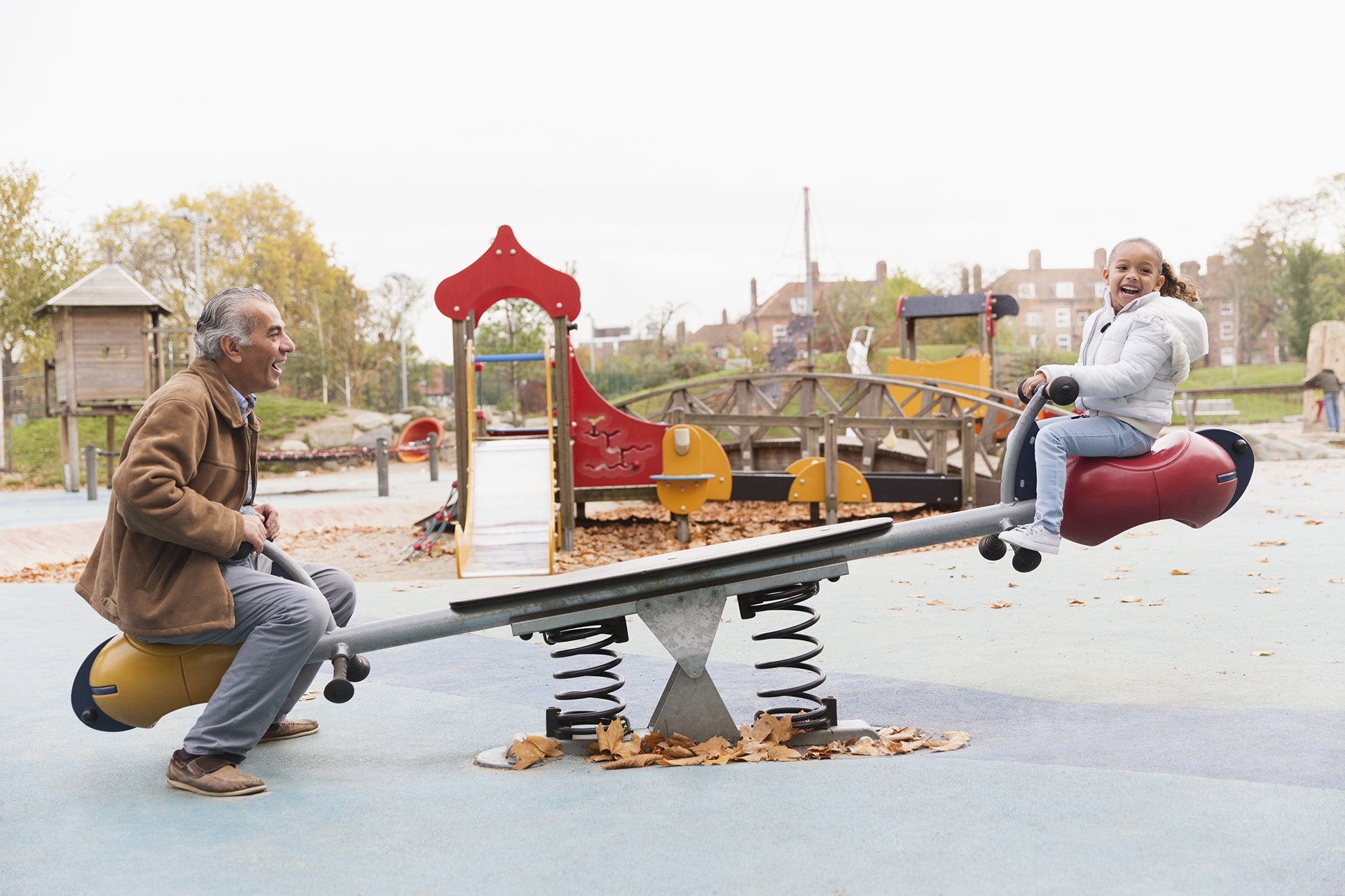 Elder man playing with child